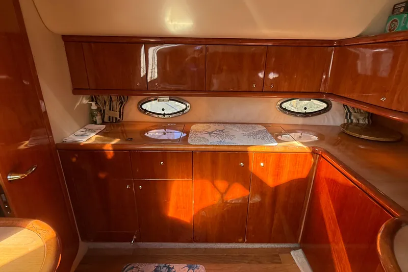  Yacht Photos Pics Luxurious wooden interior of 2002 Sunseeker Camargue 44 yacht kitchen area.