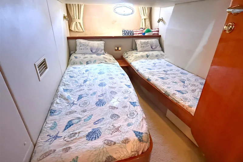  Yacht Photos Pics Twin cabin in 2002 Sunseeker Camargue 44 yacht with nautical-themed bedding.