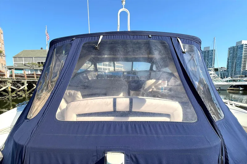  Yacht Photos Pics 2002 Sunseeker Camargue 44 yacht with blue canopy docked in marina.