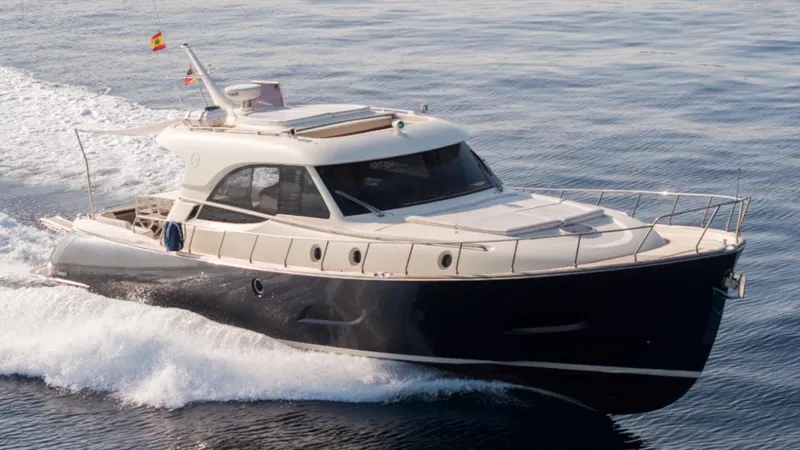 Tati Blue Yacht Photos Pics 2010 Mochi Craft 54 yacht cruising on open water, showcasing sleek design and luxury.