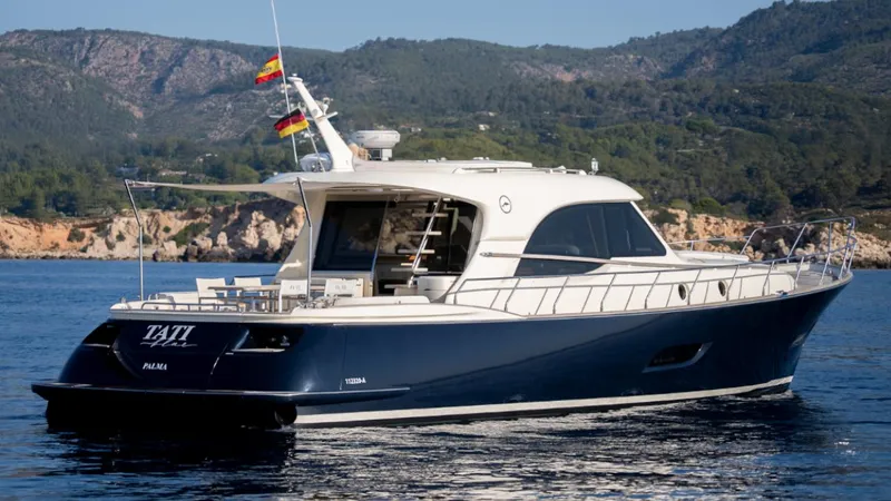 Tati Blue Yacht Photos Pics 2010 Mochi Craft 54 yacht cruising on scenic coastal waters.