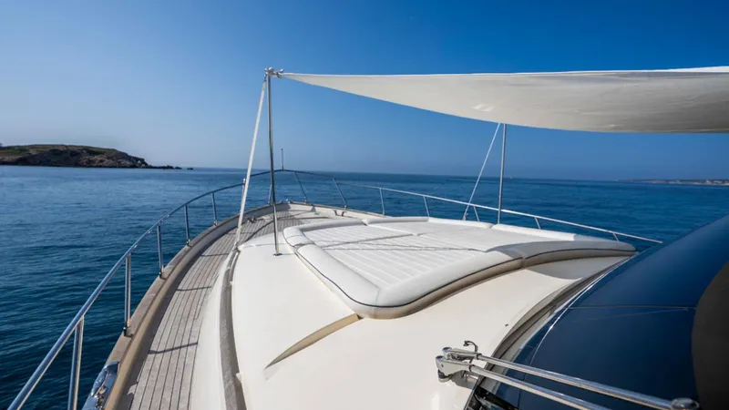 Tati Blue Yacht Photos Pics Luxurious 2010 Mochi Craft 54 yacht deck with sunshade, cruising on calm blue waters.