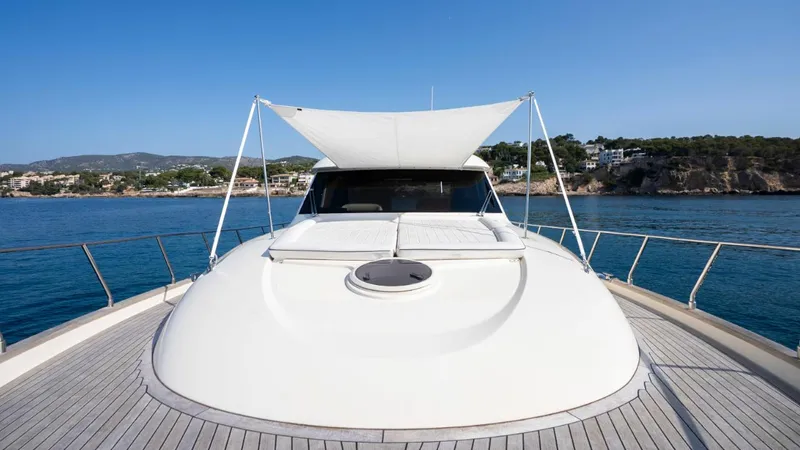 Tati Blue Yacht Photos Pics 2010 Mochi Craft 54 yacht deck with sunshade, overlooking scenic coastal view.