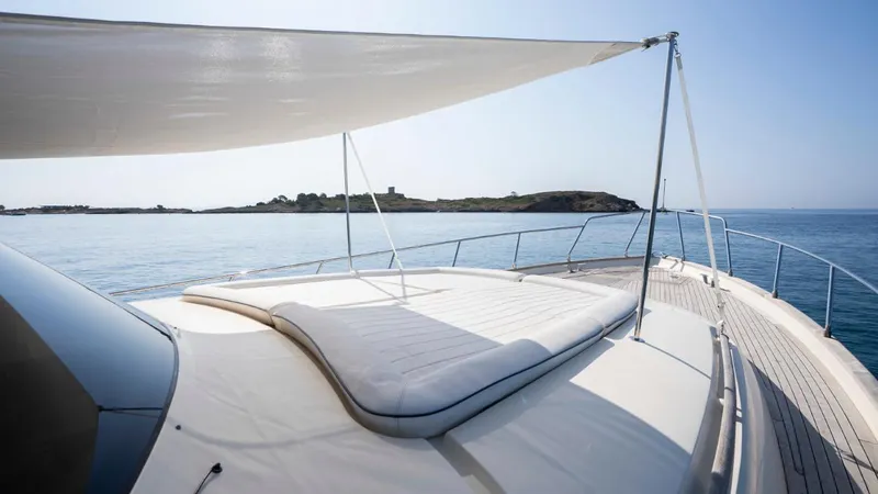 Tati Blue Yacht Photos Pics Luxurious Mochi Craft 54 yacht deck with sunshade, 2010 model, overlooking serene ocean view.