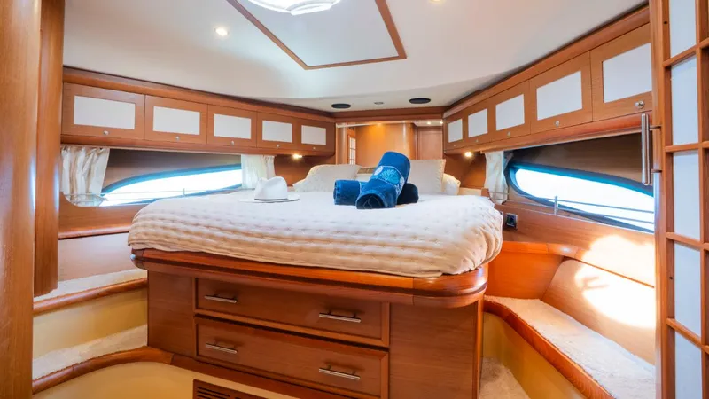 Tati Blue Yacht Photos Pics Luxurious cabin interior of 2010 Mochi Craft 54 yacht with cozy bed and elegant wood finish.