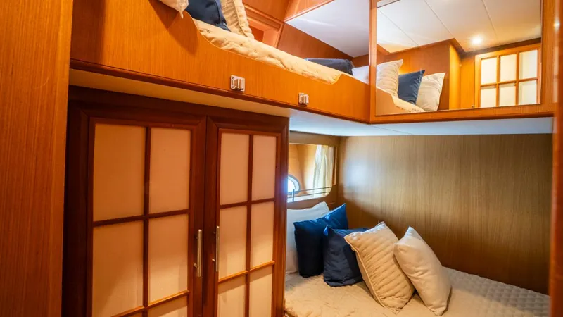 Tati Blue Yacht Photos Pics Luxurious cabin interior of 2010 Mochi Craft 54 yacht with cozy bedding and wooden accents.