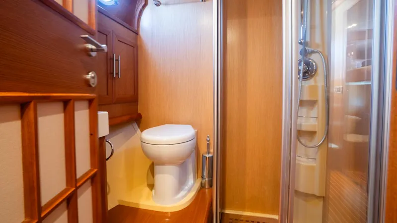 Tati Blue Yacht Photos Pics Luxurious bathroom interior of 2010 Mochi Craft 54 yacht, featuring wood accents and modern fixtures.