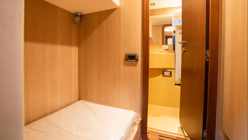 Tati Blue Yacht Photos Pics Interior cabin of 2010 Mochi Craft 54 yacht with wooden finish and cozy bed.