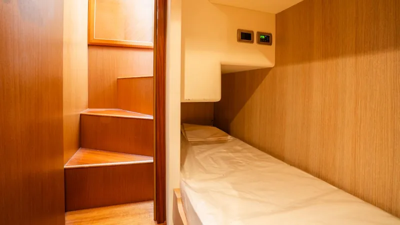 Tati Blue Yacht Photos Pics Interior of 2010 Mochi Craft 54 yacht with wooden stairs and cozy sleeping area.