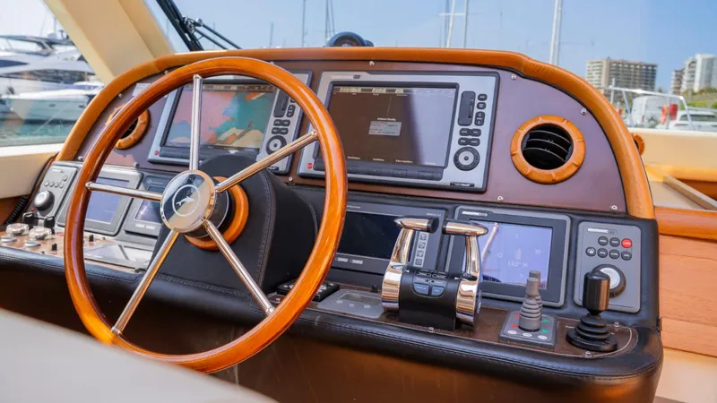 Tati Blue Yacht Photos Pics Steering wheel and dashboard of 2010 Mochi Craft 54 yacht, featuring navigation equipment.