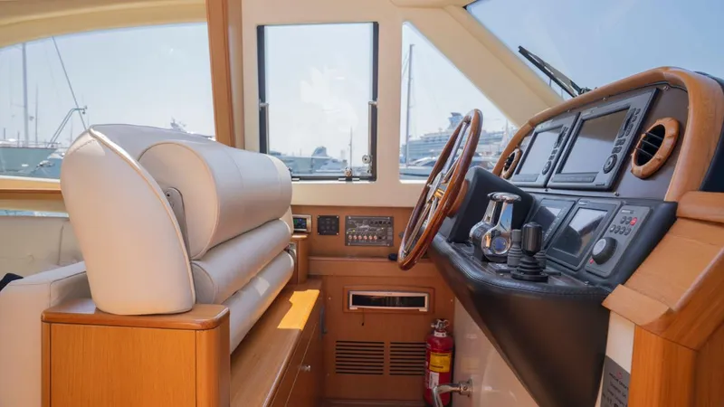 Tati Blue Yacht Photos Pics Interior helm of 2010 Mochi Craft 54 yacht with navigation equipment and leather seating.