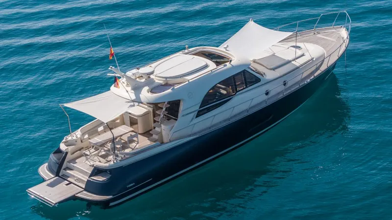 Tati Blue Yacht Photos Pics Luxurious 2010 Mochi Craft 54 yacht cruising on clear blue water.