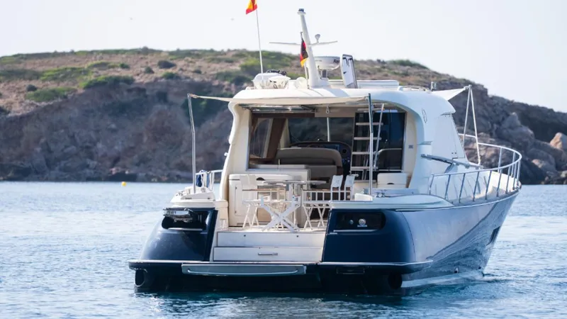 Tati Blue Yacht Photos Pics Mochi Craft 54 yacht, 2010 model, anchored near rocky coastline.