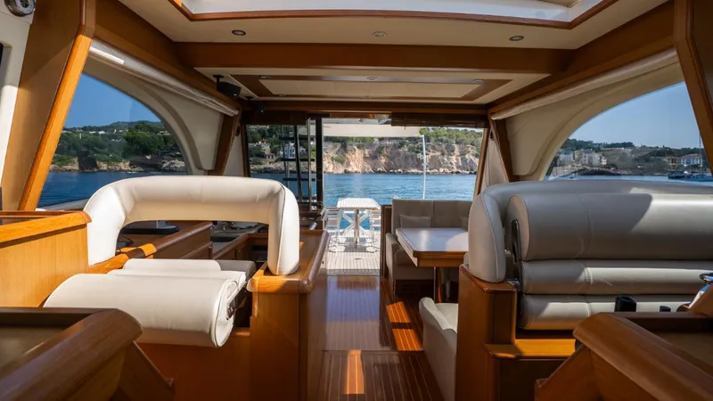 Tati Blue Yacht Photos Pics Luxurious interior of 2010 Mochi Craft 54 yacht with elegant seating and scenic ocean view.