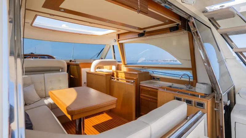 Tati Blue Yacht Photos Pics Luxurious interior of 2010 Mochi Craft 54 yacht with elegant wood finishes and ocean view.