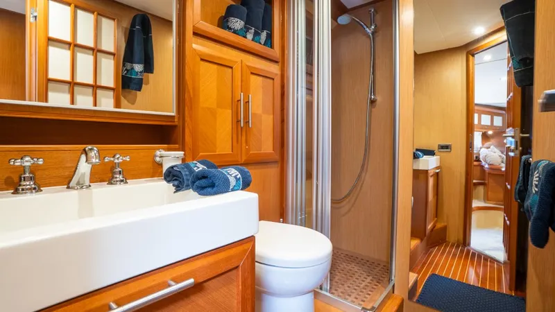 Tati Blue Yacht Photos Pics Luxurious bathroom interior of 2010 Mochi Craft 54 yacht with wooden cabinetry and modern fixtures.