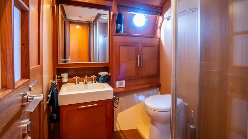Tati Blue Yacht Photos Pics Luxurious bathroom in 2010 Mochi Craft 54 yacht with wooden cabinetry and modern fixtures.