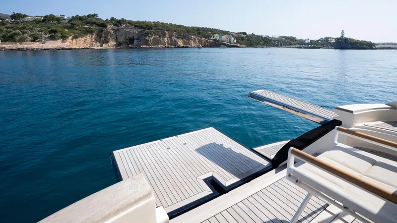 Tati Blue Yacht Photos Pics Luxury Mochi Craft 54 yacht deck overlooking serene coastal waters, 2010 model.