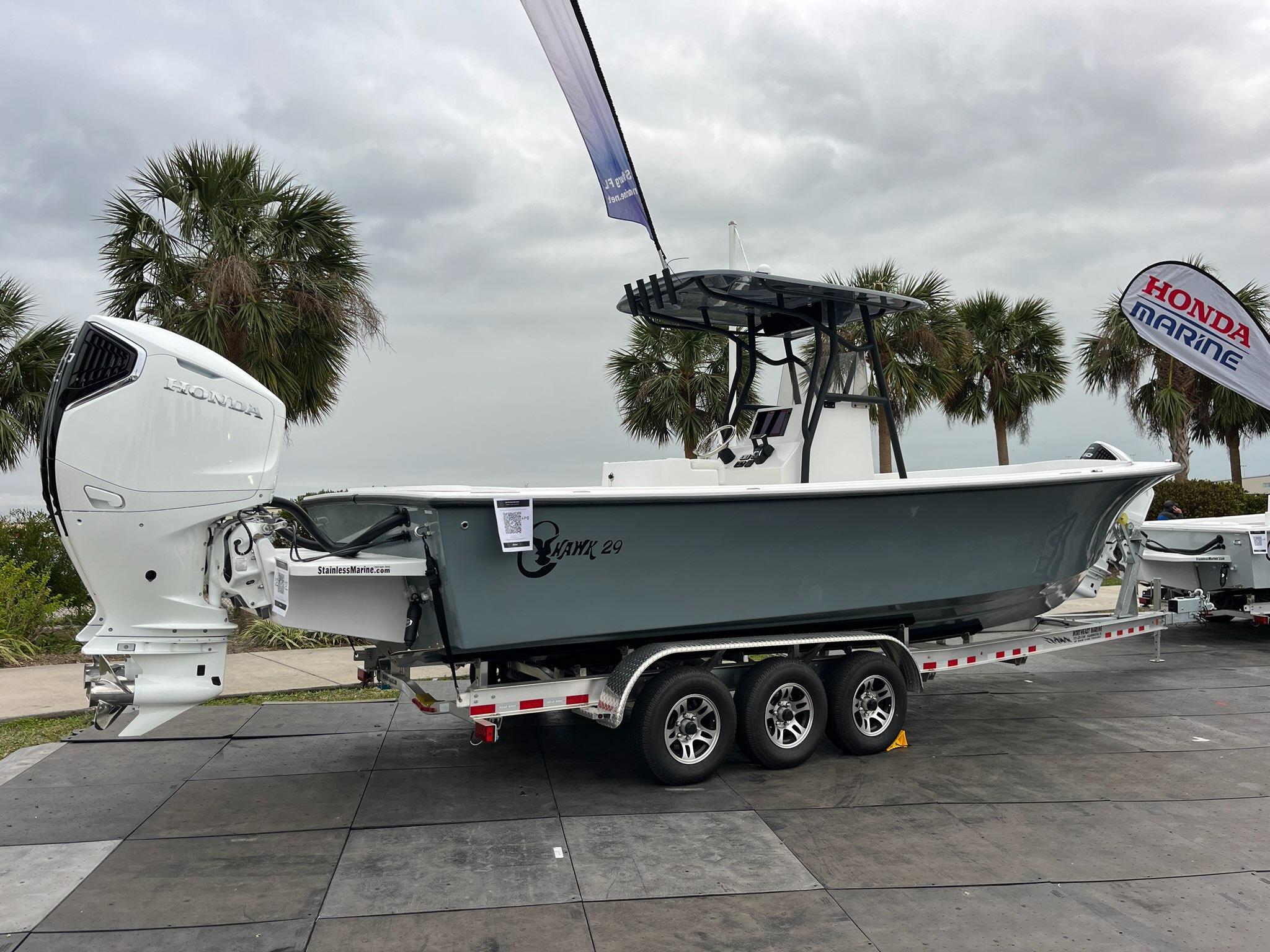 2025 C-Hawk 29 Center Console boat on trailer, displayed outdoors with palm trees.