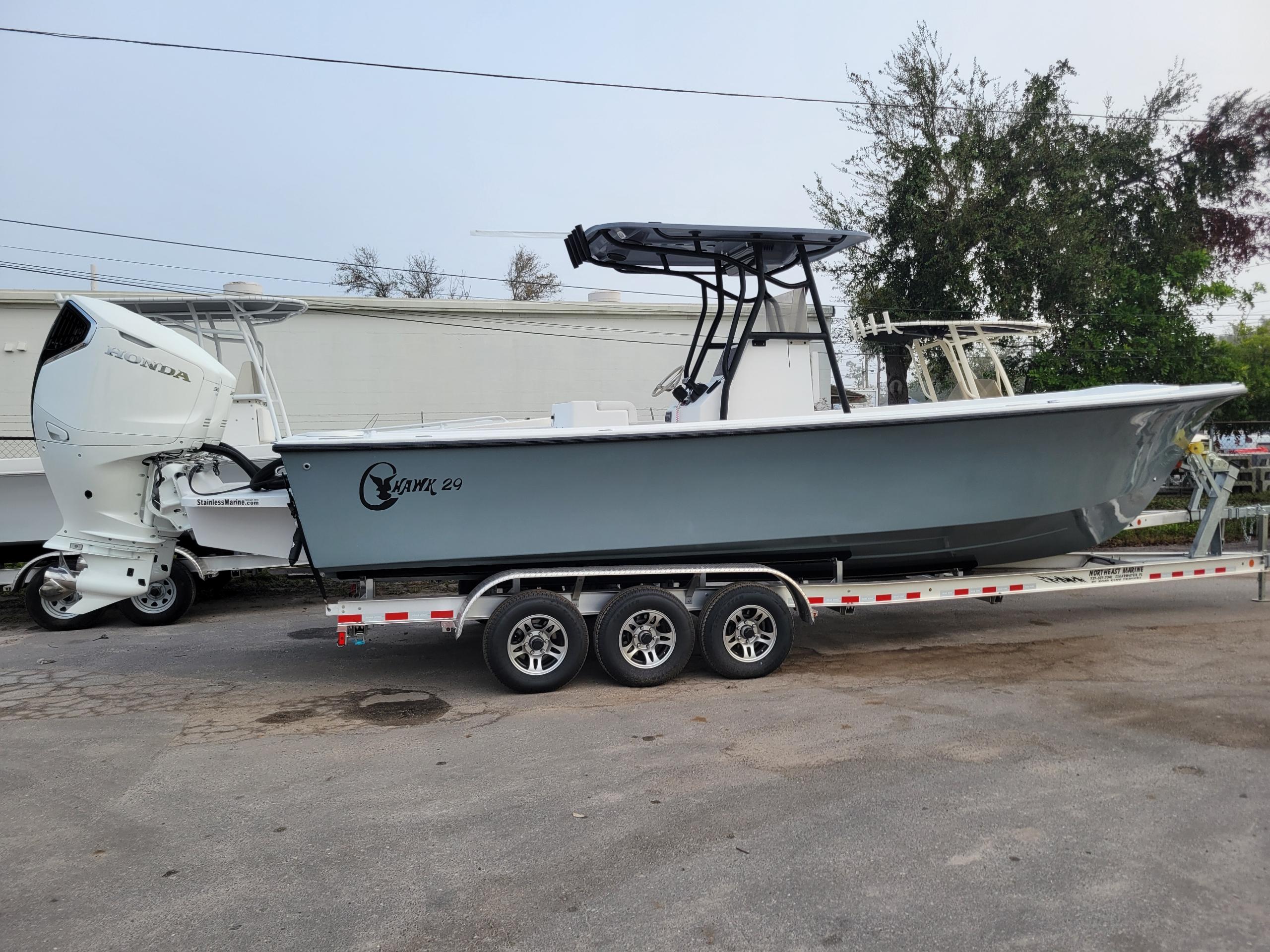 2025 C-Hawk 29 Center Console boat on trailer, featuring a sleek design and powerful engine.