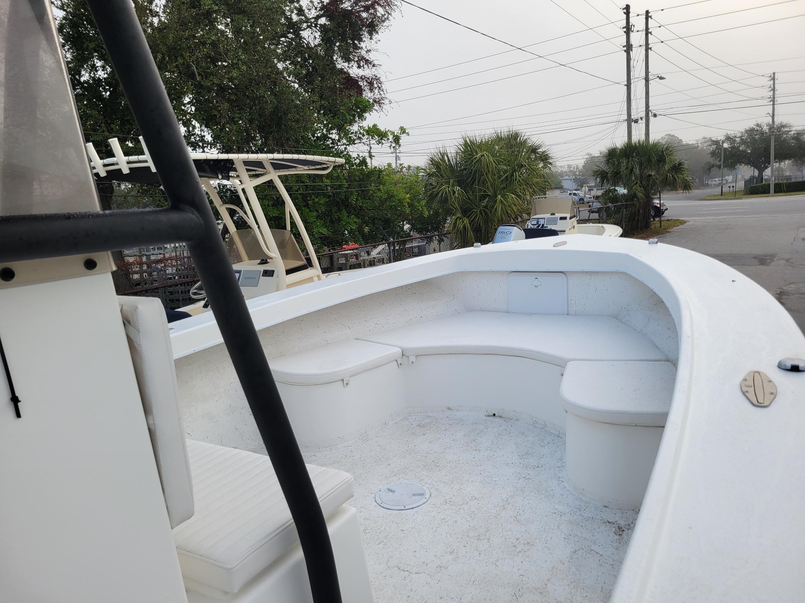2025 C-Hawk 29 Center Console boat with spacious seating, docked near trees and power lines.