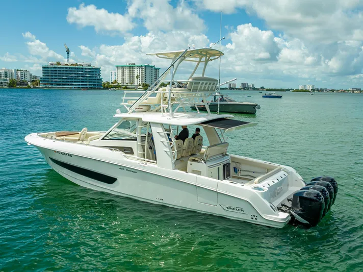  Yacht Photos Pics 2016 Boston Whaler 420 Outrage boat on calm water, cityscape in background.