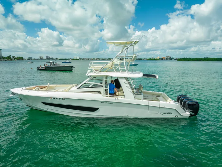  Yacht Photos Pics 2016 Boston Whaler 420 Outrage boat on calm water under a partly cloudy sky.