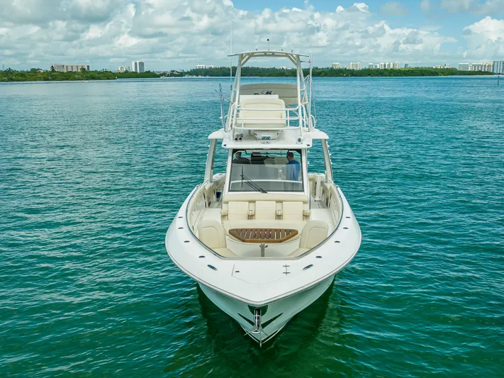  Yacht Photos Pics 2016 Boston Whaler 420 Outrage boat on calm blue water under a partly cloudy sky.
