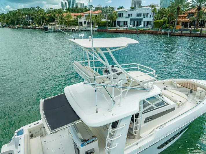  Yacht Photos Pics 2016 Boston Whaler 420 Outrage boat on a scenic waterfront with luxury homes.