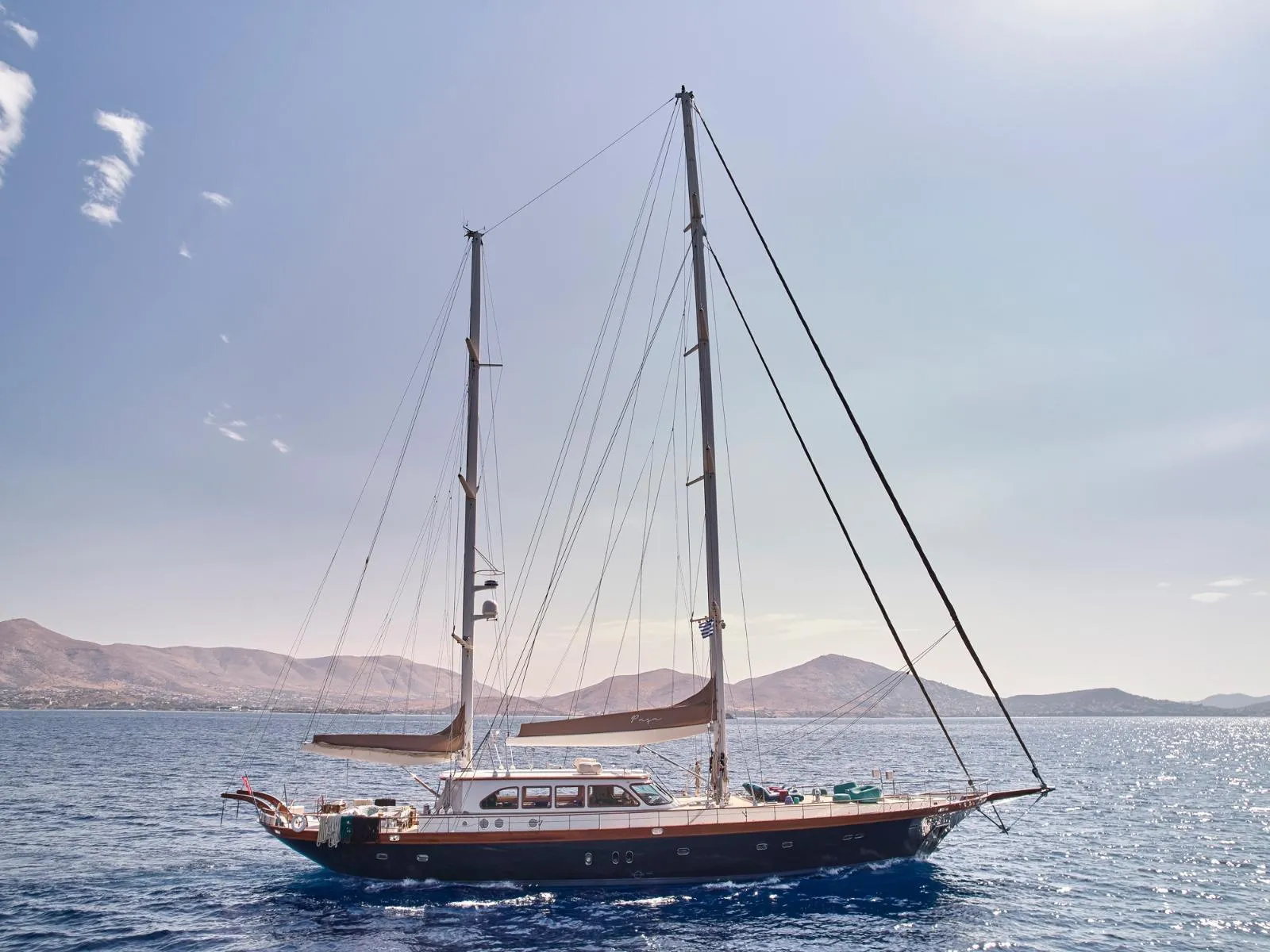 Sailing yacht on open sea with mountainous background, custom model, 2009.