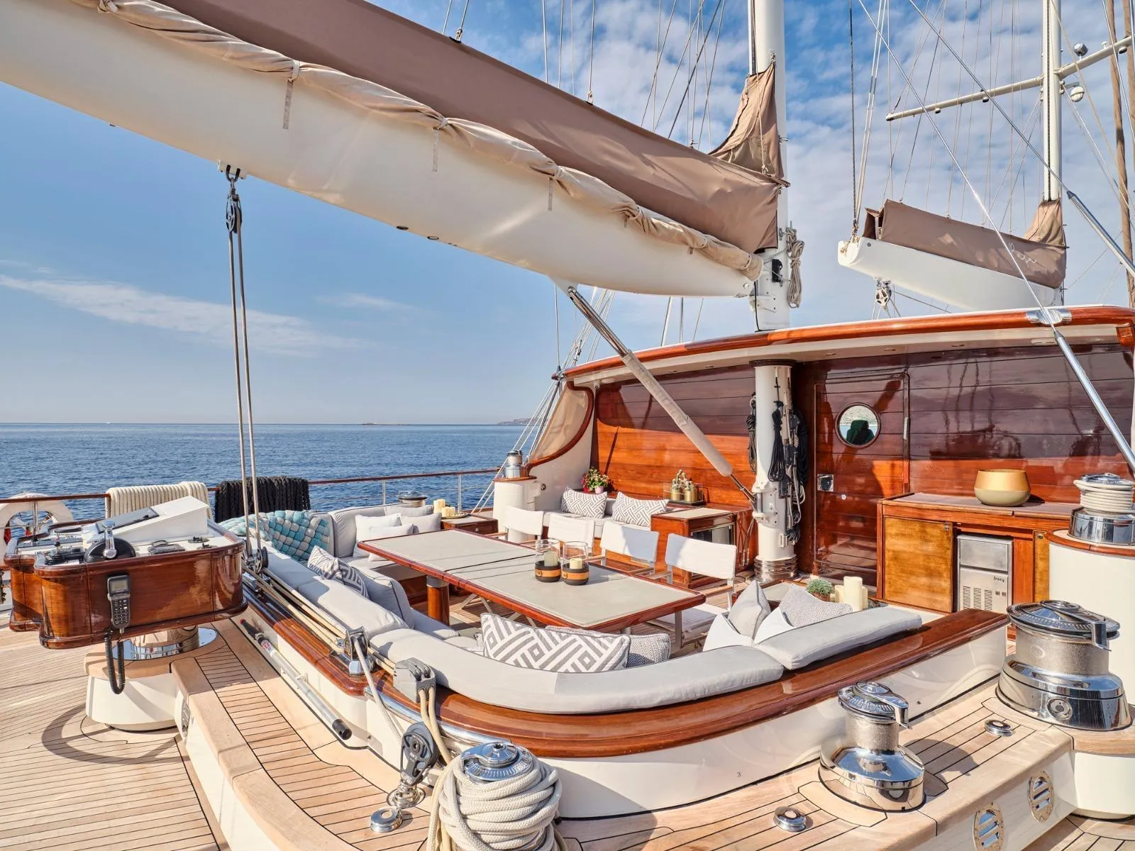 Luxurious yacht deck with elegant seating, wooden accents, and ocean view, custom model, 2009.