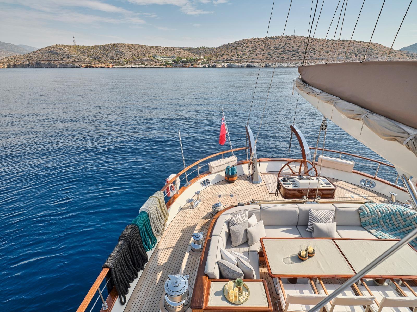 Luxurious yacht deck with seating, tables, and ocean view, custom model, 2009.