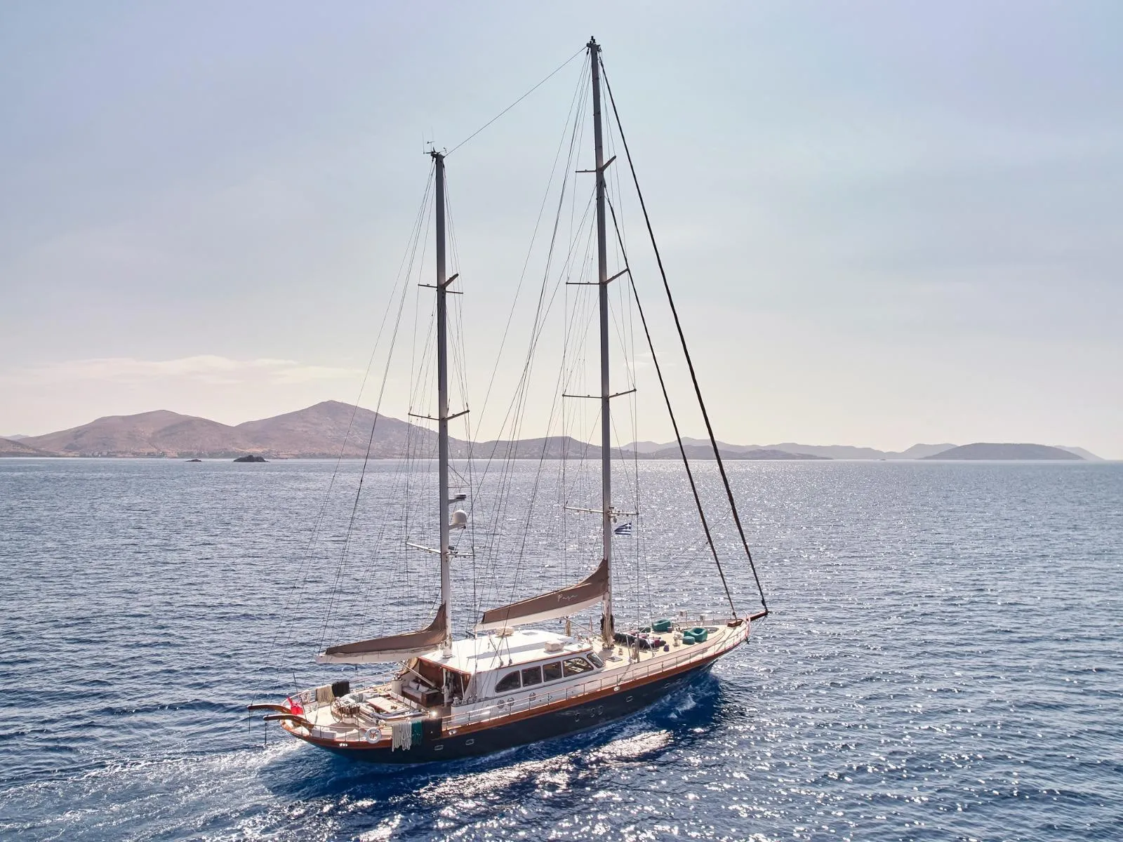 Sailing yacht on open sea with distant islands, custom model, 2009.