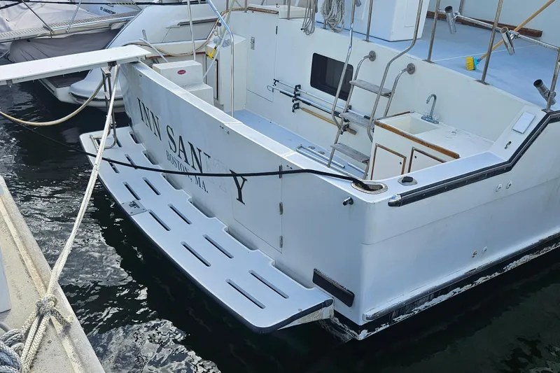  Yacht Photos Pics 1988 Cheoy Lee 51 Long Range Cockpit Motor Yacht docked, featuring spacious deck and ladder.