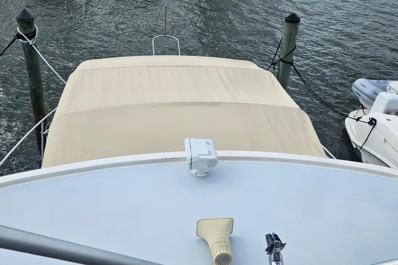  Yacht Photos Pics 1988 Cheoy Lee 51 Long Range Cockpit Motor Yacht docked with beige canopy.