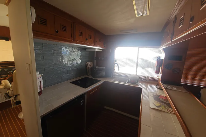  Yacht Photos Pics 1988 Cheoy Lee 51 Yacht kitchen with modern appliances and wood cabinetry.