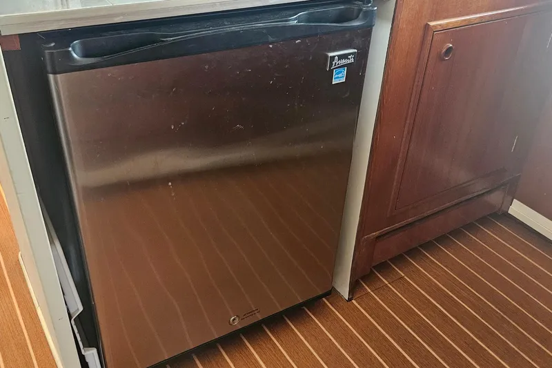  Yacht Photos Pics Stainless steel fridge in 1988 Cheoy Lee 51 Long Range Cockpit Motor Yacht kitchen.