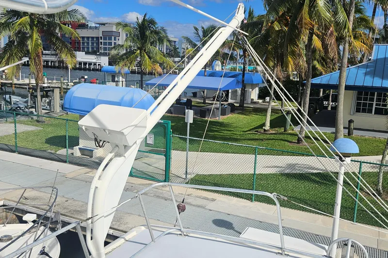  Yacht Photos Pics 1988 Cheoy Lee 51 Long Range Cockpit Motor Yacht docked near palm trees and marina.