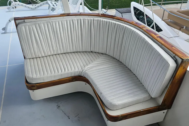  Yacht Photos Pics Curved seating on 1988 Cheoy Lee 51 Long Range Cockpit Motor Yacht, featuring white upholstery and wooden trim.