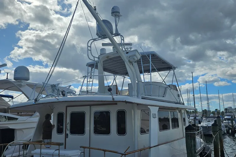  Yacht Photos Pics 1988 Cheoy Lee 51 Long Range Cockpit Motor Yacht docked under cloudy sky.