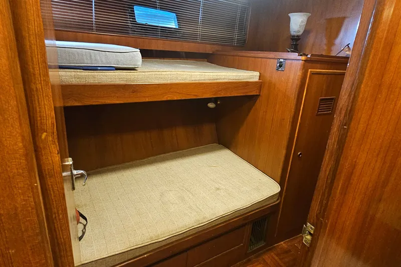  Yacht Photos Pics 1988 Cheoy Lee 51 Yacht interior with wooden bunk beds and cozy lighting.