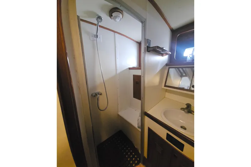  Yacht Photos Pics Bathroom interior of 1988 Cheoy Lee 51 Long Range Cockpit Motor Yacht, featuring shower and sink.
