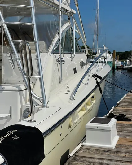  Yacht Photos Pics 2006 Rampage 38 Express yacht docked at marina, featuring sleek design and fishing equipment.