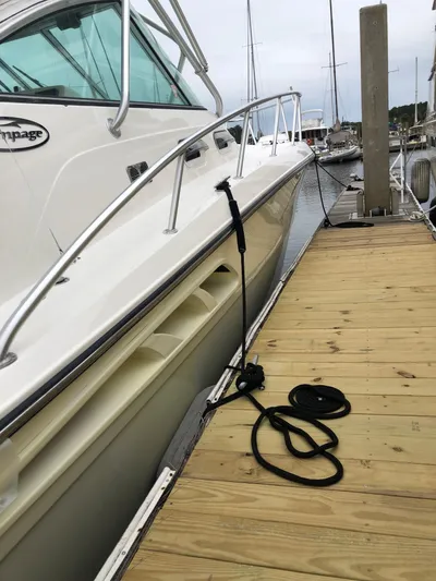  Yacht Photos Pics 2006 Rampage 38 Express boat docked at marina with wooden pier.