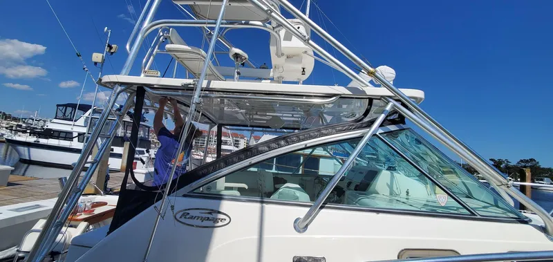  Yacht Photos Pics 2006 Rampage 38 Express boat docked, featuring sleek design and sturdy structure under clear blue sky.