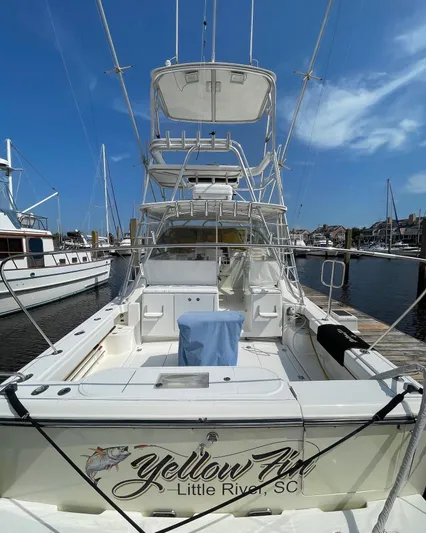  Yacht Photos Pics 2006 Rampage 38 Express boat docked, featuring spacious deck and tower, "Yellow Fin" branding.