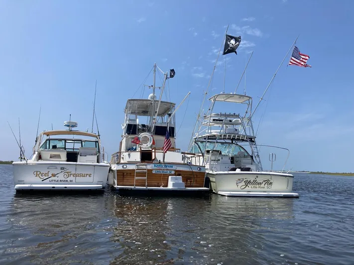  Yacht Photos Pics Three boats docked together on water, featuring a 2006 Rampage 38 Express.