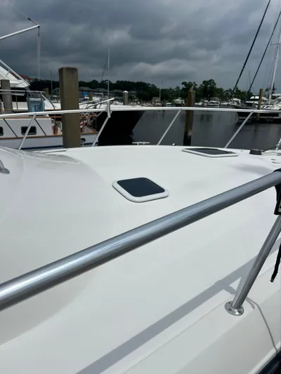 Yacht Photos Pics 2006 Rampage 38 Express boat docked at marina under cloudy sky.