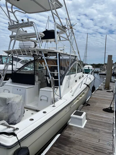  Yacht Photos Pics 2006 Rampage 38 Express boat docked at marina under cloudy sky.
