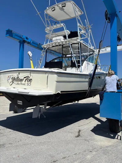  Yacht Photos Pics 2006 Rampage 38 Express boat lifted at a marina, clear blue sky background.